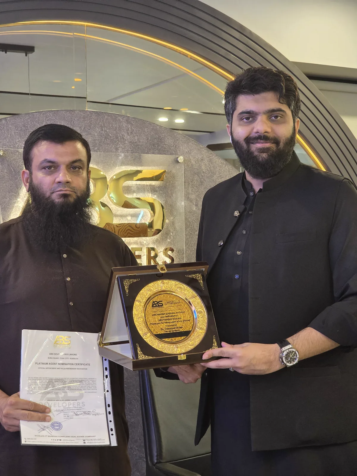 Kaaf Holdings receiving the Platinum Agent appointment certificate and recognition shield from ABS Developers for Burj Quaid